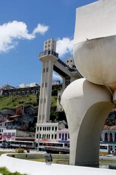 salvador, bahia / brazil - march 21, 2013: sculpture by Mario Cravo in the Comercio neighborhood and in the background the Lacerda Elevator in the city of Salvador.