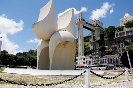 salvador, bahia / brazil - march 21, 2013: sculpture by Mario Cravo in the Comercio neighborhood and in the background the Lacerda Elevator in the city of Salvador.