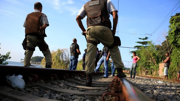 salvador, bahia / brazil - november 23, 2015: civil police investigators are investigating a murdered person near the suburban train line in the city of Salvador.