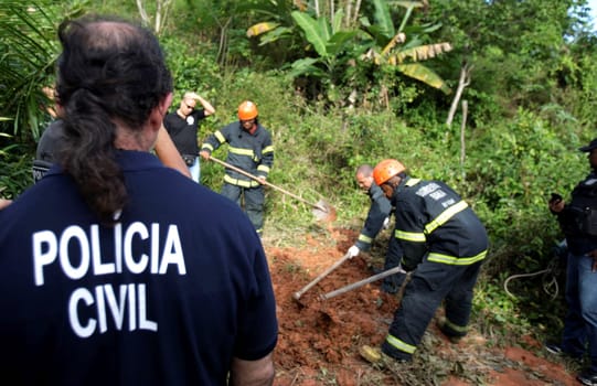 salvador, bahia / brazil - august 24, 2015: civil police investigators are investigating a person murdered in the bush area in the city of Salvador.