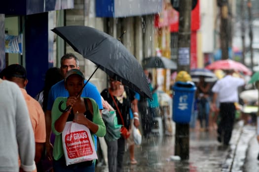 salvador, bahia / brazil - august 26, 2016: People are seen using umbrella during rain in the city of Salvador.
