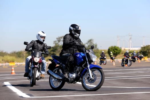 campinas, sao paulo / brazil - july 31, 2013: motorcyclists are seen during test drive with Honda model CG motorcycles in the city of Campinas.