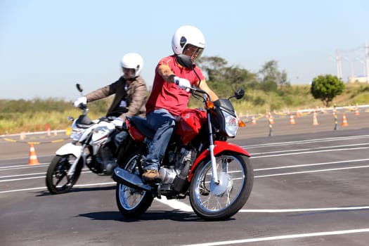 campinas, sao paulo / brazil - july 31, 2013: motorcyclists are seen during test drive with Honda model CG motorcycles in the city of Campinas.