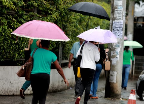salvador, bahia / brazil - august 26, 2016: People are seen using umbrella during rain in the city of Salvador.