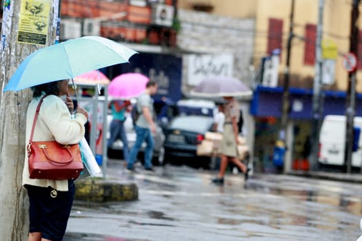 salvador, bahia / brazil - august 26, 2016: People are seen using umbrella during rain in the city of Salvador.