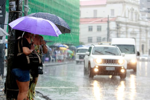 salvador, bahia / brazil - august 26, 2016: People are seen using umbrella during rain in the city of Salvador.