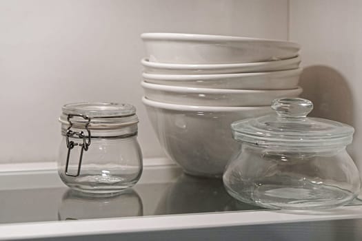 Bowls and jars dishes at glass shelf