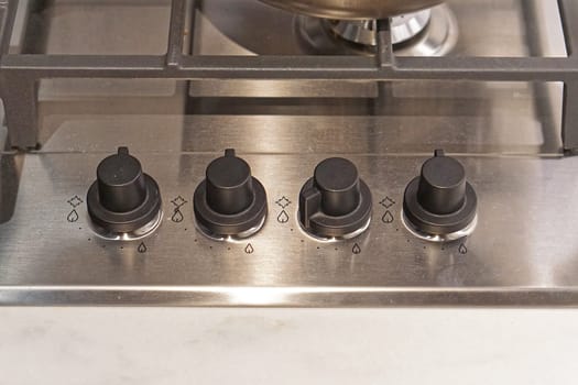 Four controls buttons at gas burning stove