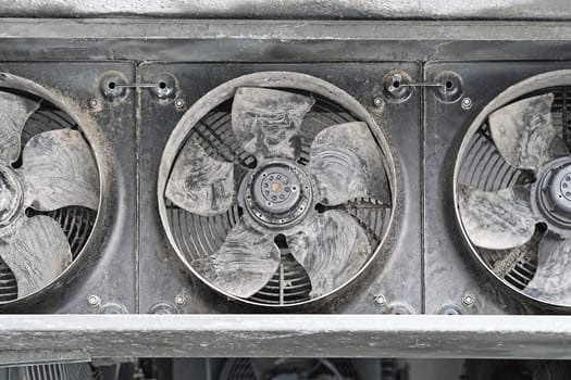 Industrial cooling fans covered with dirt and dust