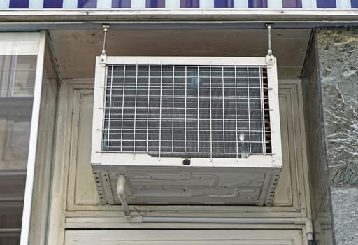 Window air conditioner unit above door
