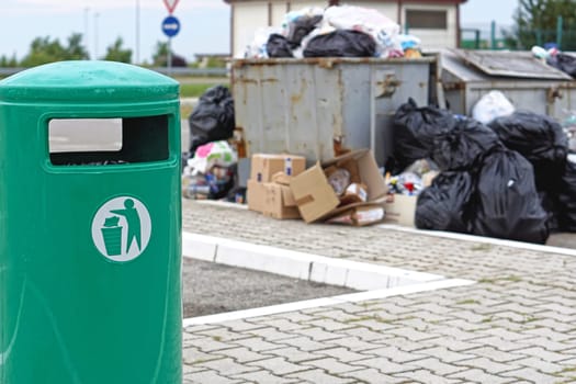 Overflow of garbage litter and empty trash can