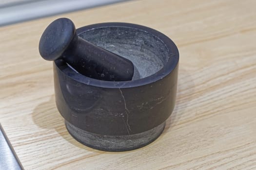 Black stone mortar and pestle at kitchen coutertop
