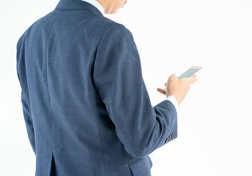 Businessman in suit holding a smartphone over white background