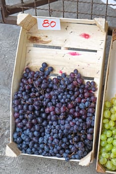 Red grapes in wooden crate