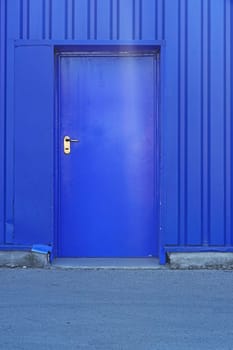 Blue door at industrial building exterior