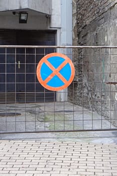 No parking warning traffic sign at fence