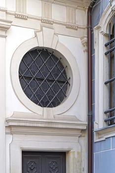 Round window with bars above door