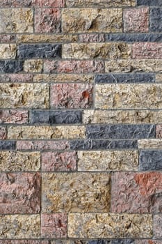 Limestone tiles with rough surface at house wall