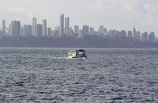 salvador, bahia / brazil - november 3, 2014: motorboat is seen sailing through Baia de Todos os Santos during the crossing from Vera Cruz Island to the city of Salvador.