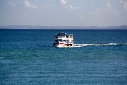 salvador, bahia / brazil - november 3, 2014: motorboat is seen sailing through Baia de Todos os Santos during the crossing from Vera Cruz Island to the city of Salvador.