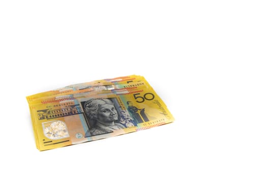 Stack of Australian 50 dollars banknotes isolated over white background with copy space, cash is king concept image