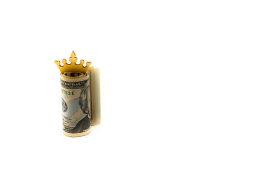Stack of US dollars with golden crown isolated over white background with copy space, cash is king concept image