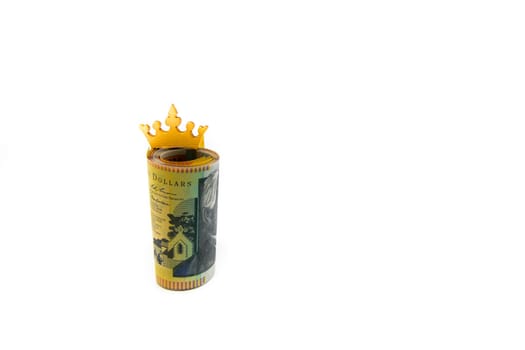 Stack of Australian 50 dollars banknotes with golden crown isolated over white background with copy space, cash is king concept image