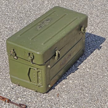 Green metal army ammo box at street