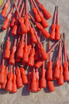 Big bunch of red screwdrivers with insulation protection