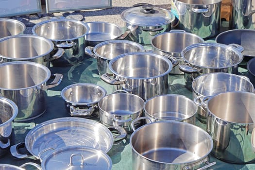 Many stainless steel metal cooking pots