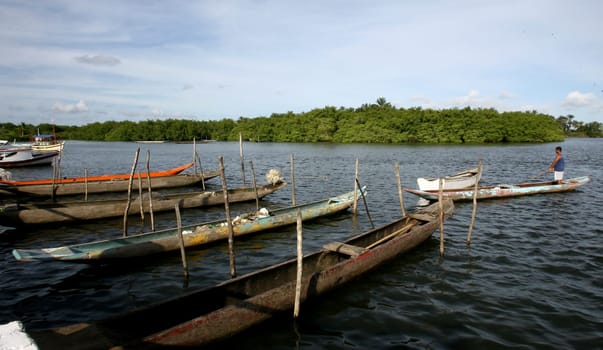 camamu, bahia / brazil - january 10, 2012: canoes are seen in Baia de Camamu, in the city of Camamu, in southern Bahia.