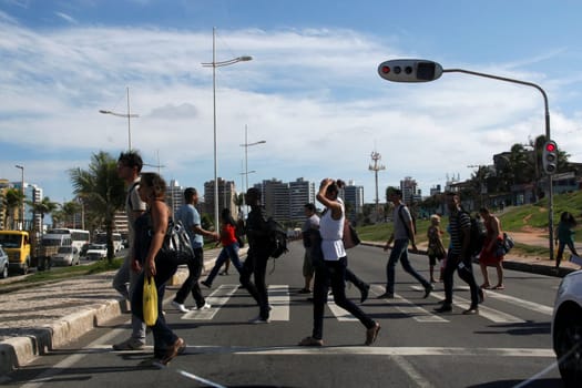 salvador, bahia / brazil - may 8, 2013: people are seen crossing the street in a pedestrian lane in the city of Salvador, Bahia.