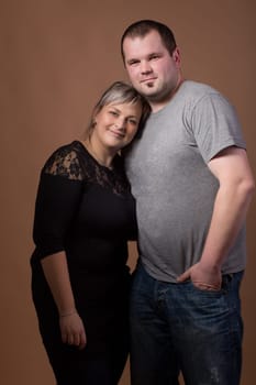 Studio shoot of beautiful fashion xxl woman with her husband, happy couple love concept