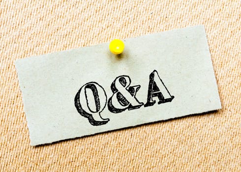 Recycled paper note pinned on cork board. Q&A Message. Concept Image