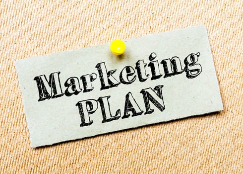 Recycled paper note pinned on cork board. Marketing Plan message. Concept Image