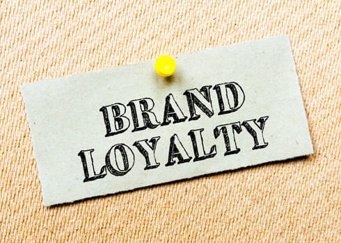 Recycled paper note pinned on cork board. Brand Loyalty Message. Concept Image
