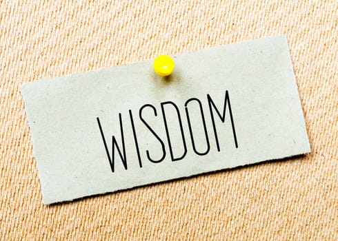 Recycled paper note pinned on cork board.Wisdom  Message. Concept Image