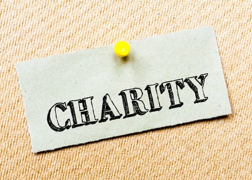 Recycled paper note pinned on cork board. Charity Message. Concept Image