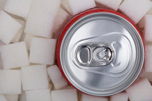 White sugar cubes with soda can fullframe as background