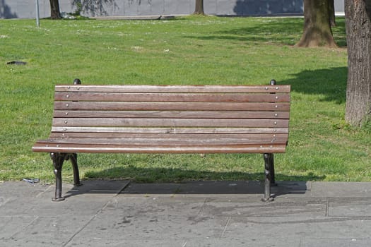 Classic style wooden bench in city park