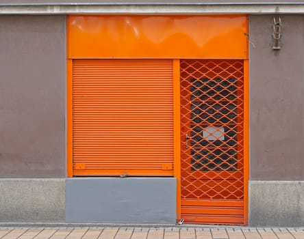 Orange blinds at small closed shop