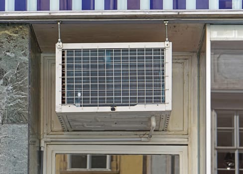 Window air conditioner unit above door