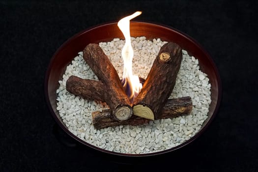 Fake fire in decorative tray at home