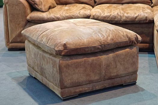 Big leather footstool in living room