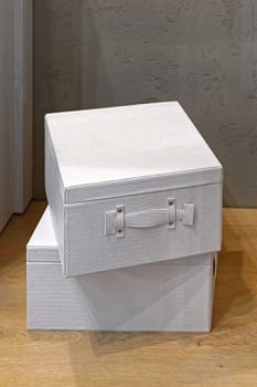 Two white boxes stacked at floor