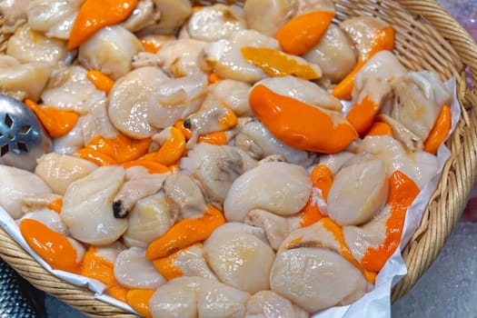 Big pile of fresh scallops in basket