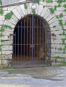 Stone arch doorway with iron bars door