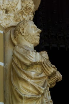 Fourteenth century statue of St. Peter stands outside the entrance of Sé Cathedral in Évora Portugal. Shot in natural sunlight with copy space.