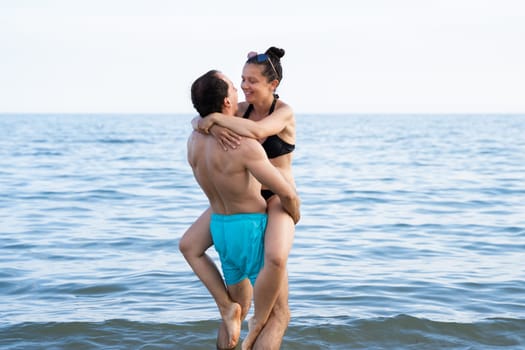 Lifting Woman At Beach At Sea In Summer