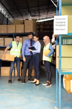 Factory reopen signage with warehouse manager and worker meeting in background after city lockdown from COVID-19 coronavirus pandemic in warehouse distribution center environment.